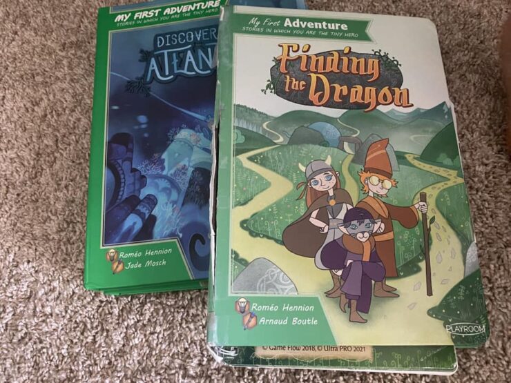 Two children's adventure books titled "Discover Atlantis" and "Finding the Dragon," featuring colorful illustrations and characters. The books are part of the "My First Adventure" series, encouraging interactive storytelling for young readers.