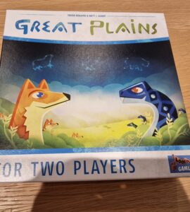 Board game box for "Great Plains," designed for two players, featuring colorful illustrations of a fox and a dinosaur in a vibrant natural landscape.