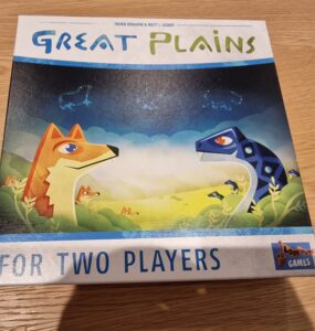 Board game box for "Great Plains," designed for two players, featuring colorful illustrations of a fox and a dinosaur in a vibrant natural landscape.