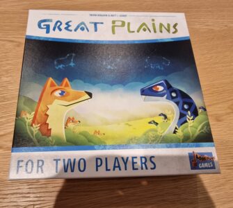 Board game box for "Great Plains," designed for two players, featuring colorful illustrations of a fox and a dinosaur in a vibrant natural landscape.