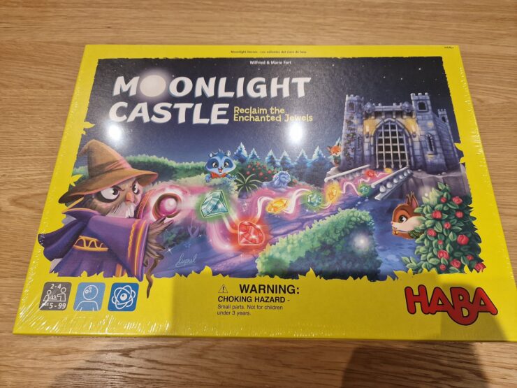 Colorful board game box for "Moonlight Castle" by HABA, featuring a whimsical wizard, enchanted jewels, and a castle backdrop. Designed for 2-4 players aged 5 and up, this game invites players to reclaim magical gems in a charming fantasy setting.