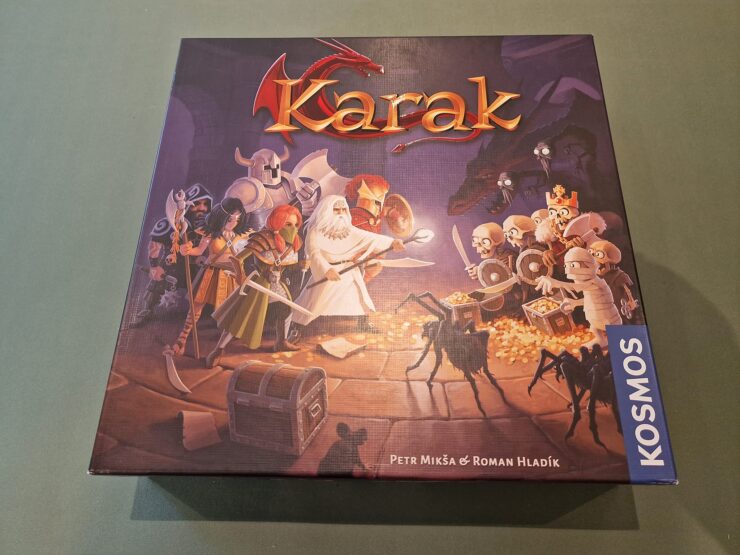 Board game "Karak" box featuring colorful artwork of heroes and skeletons, designed by Petr Mikša and Roman Hladík, published by Kosmos.