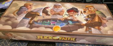 Colorful board game box for "Flick of Faith," featuring mythological characters including gods and a sphinx, with vibrant illustrations and game components displayed.