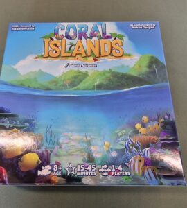 Colorful board game box for "Coral Islands," featuring vibrant underwater scenes with fish and coral. Designed by Richard Maass and Rohan Dargad, suitable for ages 8 and up, for 1-4 players, with a playtime of 15-45 minutes.