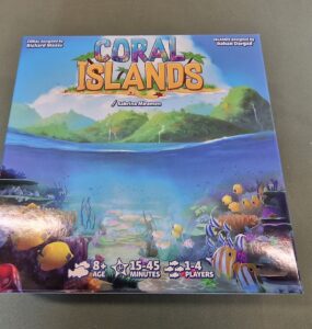 Colorful board game box for "Coral Islands," featuring vibrant underwater scenes with fish and coral. Designed by Richard Maass and Rohan Dargad, suitable for ages 8 and up, for 1-4 players, with a playtime of 15-45 minutes.