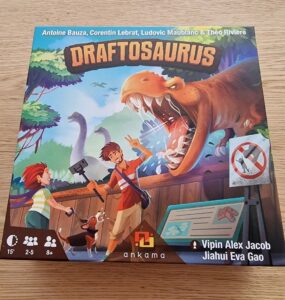 Image of the board game "Draftosaurus" featuring colorful artwork of children interacting with dinosaurs. The game box displays a T-Rex and includes details such as the names of the designers and the recommended age, player count, and playtime, emphasizing its family-friendly gameplay suitable for ages 8 and up.