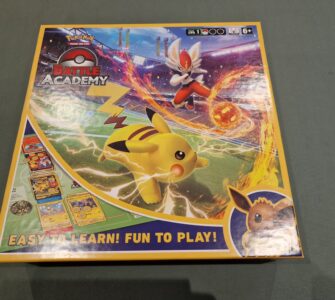 Pokemon Battle Academy board game box featuring Pikachu and an action scene with a character using a fire attack. The design highlights the game’s accessibility with the tagline "Easy to Learn! Fun to Play!" Suitable for ages 6 and up.