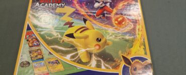 Pokemon Battle Academy board game box featuring Pikachu and an action scene with a character using a fire attack. The design highlights the game’s accessibility with the tagline "Easy to Learn! Fun to Play!" Suitable for ages 6 and up.