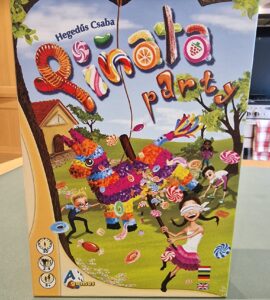 Colorful board game box for "Pinata Party" by Hegedús Csaba, featuring a vibrant piñata and children playing. The design highlights fun candy graphics, game details, and player information, suitable for 2-4 players aged 8 and up.