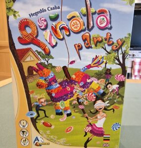 Colorful board game box for "Pinata Party" by Hegedús Csaba, featuring a vibrant piñata and children playing. The design highlights fun candy graphics, game details, and player information, suitable for 2-4 players aged 8 and up.