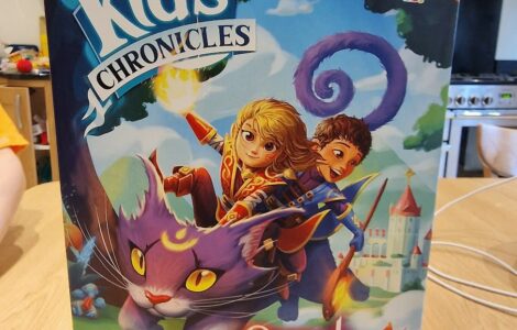 Colorful board game box titled "Kids Chronicles: Quest for the Moon Stones," featuring adventurous characters riding a magical purple cat against a whimsical background. Suitable for ages 7 and up, designed by David Cicurel, published by Lucky Duck Games.