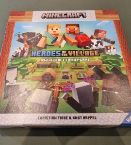 Minecraft Heroes of the Village board game box featuring colorful graphics, characters, and gameplay elements. Designed for 2-4 players aged 7 and up, created by Christian Fiore and Knut Happel, published by Ravensburger.