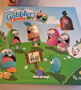 Colorful board game box for "Gobblers Family Mix" featuring playful characters in a grassy landscape, designed for 2-5 players aged 5 and up, by Blue Orange Games and Jürgen Heel.