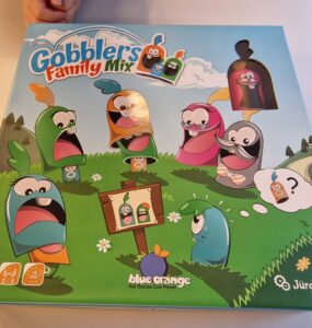 Colorful board game box for "Gobblers Family Mix" featuring playful characters in a grassy landscape, designed for 2-5 players aged 5 and up, by Blue Orange Games and Jürgen Heel.