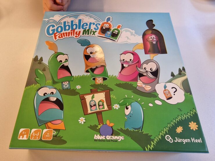 Colorful board game box for "Gobblers Family Mix" featuring playful characters in a grassy landscape, designed for 2-5 players aged 5 and up, by Blue Orange Games and Jürgen Heel.