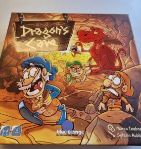 Colorful board game box for "Dragon's Cave" featuring whimsical characters, a dragon, and a treasure-filled cave setting. Designed for 2-4 players, ages 7 and up, with a playtime of approximately 25 minutes. Created by Marco Teubner, Sylvain Aublin, and Stivo, published by Blue Orange Games.