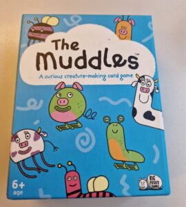 Colorful box of "The Muddles," a creature-making card game for ages 6 and up, featuring whimsical illustrations of various cartoon animals and characters.