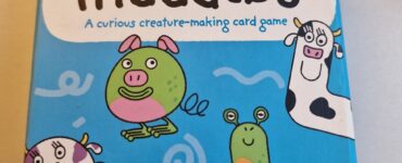 Colorful box of "The Muddles," a creature-making card game for ages 6 and up, featuring whimsical illustrations of various cartoon animals and characters.