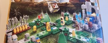 LEGO Heroica Waldurk board game box featuring a colorful game layout with miniature characters, trees, and a dice, designed for 2-3 players aged 8 and up, with an estimated playtime of 10-15 minutes.