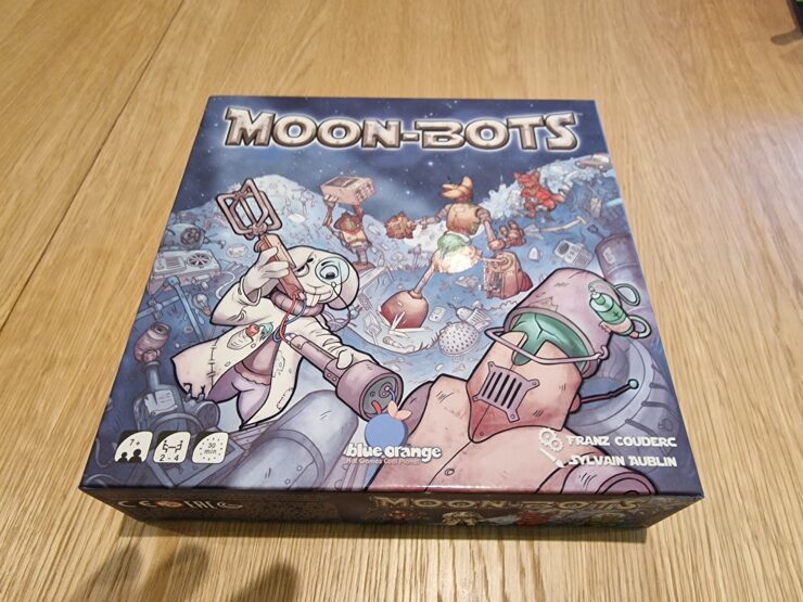 Board game "Moon-Bots" featuring colorful artwork of robots on a lunar landscape, designed for 2-4 players aged 7 and up, with an estimated playtime of 30 minutes.