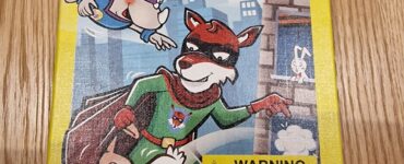 Colorful board game box for "Rhino Hero: Missing Match" by HABA, featuring cartoon characters including a superhero rhino, a cat, and a mouse. The box highlights the game's age recommendation (4-99 years) and includes a choking hazard warning. Ideal for family game nights and children's entertainment.