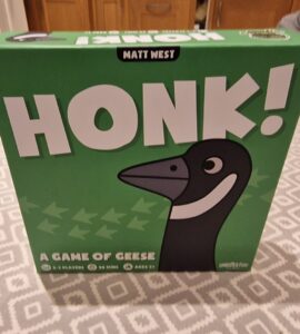 Image of the board game "Honk!" by Matt West, featuring a cartoon goose on the box cover. The game is designed for 2-5 players, takes about 20 minutes to play, and is suitable for ages 8 and up. The box is predominantly green with playful graphics.