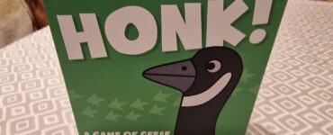 Image of the board game "Honk!" by Matt West, featuring a cartoon goose on the box cover. The game is designed for 2-5 players, takes about 20 minutes to play, and is suitable for ages 8 and up. The box is predominantly green with playful graphics.