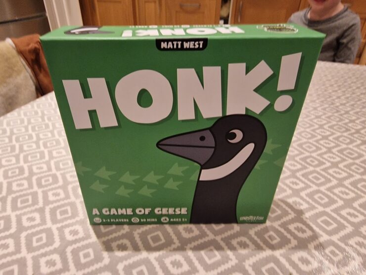 Image of the board game "Honk!" by Matt West, featuring a cartoon goose on the box cover. The game is designed for 2-5 players, takes about 20 minutes to play, and is suitable for ages 8 and up. The box is predominantly green with playful graphics.