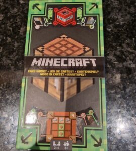 Minecraft card game packaging featuring a TNT block, crafting table, and player instructions. Suitable for 2-4 players aged 8 and up.