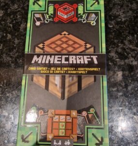 Minecraft card game packaging featuring a TNT block, crafting table, and player instructions. Suitable for 2-4 players aged 8 and up.