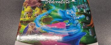 Board game box for "Ghost Adventure" featuring colorful artwork of characters in a whimsical forest setting. The game is suitable for ages 8 to 99, supports 1 to 4 players, and has an average playtime of 20 minutes. Branding includes Spinboard and Buzzing Games logos.