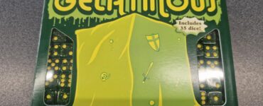 Box of the board game "Gelatinous" by Steve Jackson Games, featuring vibrant green packaging and illustrations of a gelatinous creature, swords, and shields. Includes 35 dice for gameplay.