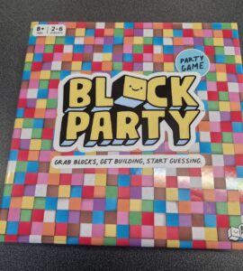 Colorful board game box titled "Block Party," designed for 2-6 players aged 8 and up, featuring the tagline "Grab blocks, get building, start guessing." The box is adorned with a vibrant, patterned background.