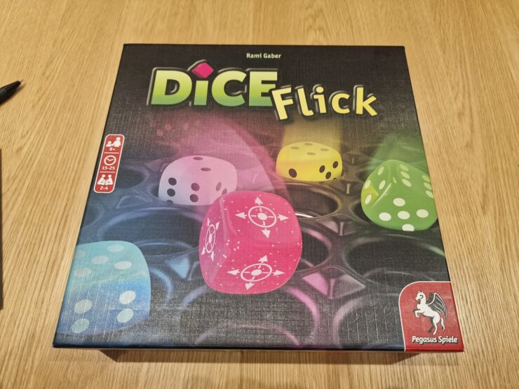 Board game Dice Flick by Rami Gaber, featuring colorful dice on the box cover, suitable for 2-4 players aged 8 and up, with a playtime of 15-25 minutes.