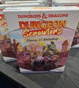 Dungeons & Dragons Dungeon Scrawlers: Heroes of Waterdeep board game box displayed at a gaming convention, featuring colorful artwork of characters preparing for adventure.