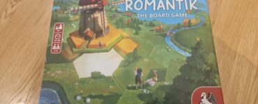 Box of Dorf Romantik: The Board Game featuring a colorful illustration of a windmill and a scenic landscape. Designed for 1-6 players aged 8 and up, with gameplay lasting 30-60 minutes. Created by Lukas Zach and Michael Palm, published by Pegasus Spiele.