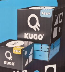 Kugo game boxes displayed against a blue and black background, featuring the words "PLAY," "TRIX," and "BUILD," showcasing the interactive and creative nature of the game.