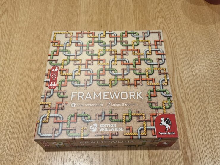 Board game "Framework" by Uwe Rosenberg and Lukas Siegmon, featuring a colorful pipe design on the box cover. Suitable for 1-4 players, ages 8 and up, with a playtime of approximately 30 minutes. Published by Pegasus Spiele.