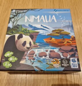 Nimala board game box featuring a panda illustration, designed by Pauline Détraz, suitable for 2-4 players aged 10 and up, with an average playtime of 30 minutes. The artwork showcases a vibrant landscape with animals and nature elements.