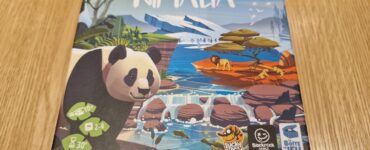 Nimala board game box featuring a panda illustration, designed by Pauline Détraz, suitable for 2-4 players aged 10 and up, with an average playtime of 30 minutes. The artwork showcases a vibrant landscape with animals and nature elements.