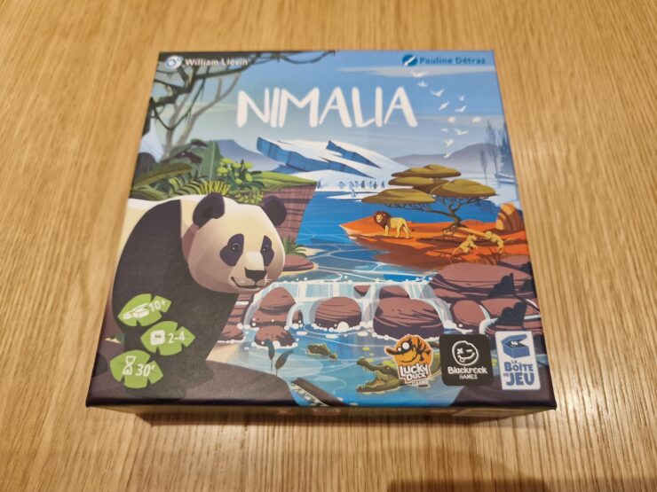 Nimala board game box featuring a panda illustration, designed by Pauline Détraz, suitable for 2-4 players aged 10 and up, with an average playtime of 30 minutes. The artwork showcases a vibrant landscape with animals and nature elements.