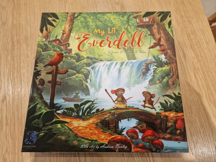 Cover of the board game "My Lil' Everdell," featuring vibrant artwork by Andrew Bosley. The illustration showcases a whimsical forest scene with characters like mice and frogs, a waterfall, and lush greenery, highlighting the enchanting world of Everdell. Perfect for family game nights and young players.