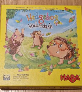 Colorful board game box for "Hedgehog Haberdash" by HABA, featuring playful hedgehogs and autumn leaves. Suitable for ages 3 and up, ideal for family game nights.