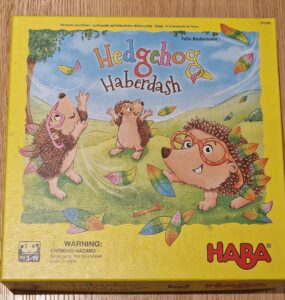 Colorful board game box for "Hedgehog Haberdash" by HABA, featuring playful hedgehogs and autumn leaves. Suitable for ages 3 and up, ideal for family game nights.