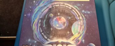 Colorful board game box for "Wormholes" by Peter McPherson, featuring a cosmic design with swirling galaxies and planets, highlighting its space-themed gameplay.