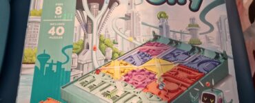 Box cover of the LogiQuest game "Zip City," featuring a futuristic cityscape, a maze-building puzzle with colorful pieces, and a robot character. Designed for single players aged 8 and up, the game includes 40 puzzles that challenge players to navigate marbles to their correct destinations.