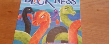 Colorful board game "Block Ness" featuring cartoon-style sea monsters, designed for 2-4 players aged 8 and up. The box showcases vibrant illustrations of various mythical creatures against a scenic background, highlighting the game's playful theme.