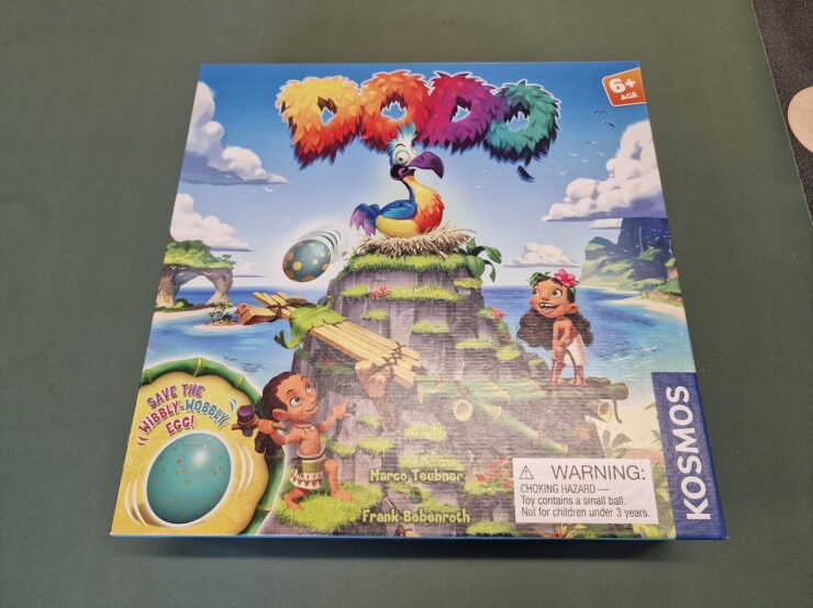 Colorful board game "Dodo" featuring a vibrant dodo bird on a tropical island, with children playing and an egg illustration. Suitable for ages 6 and up, designed by Marco Teubner and Frank Bebenroth, published by Kosmos.