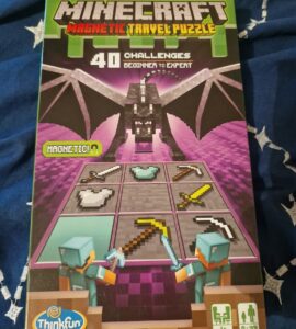 Minecraft Magnetic Travel Puzzle featuring 40 challenges for players of all skill levels, designed by Thinkfun. The game includes iconic Minecraft characters and tools, ideal for on-the-go fun.