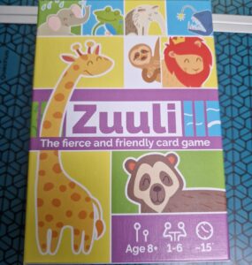 Colorful box of the card game "Zuuli," featuring playful animal illustrations including a giraffe, sloth, lion, and more. The design highlights that the game is suitable for ages 8 and up, supports 1 to 6 players, and has a playtime of approximately 15 minutes.